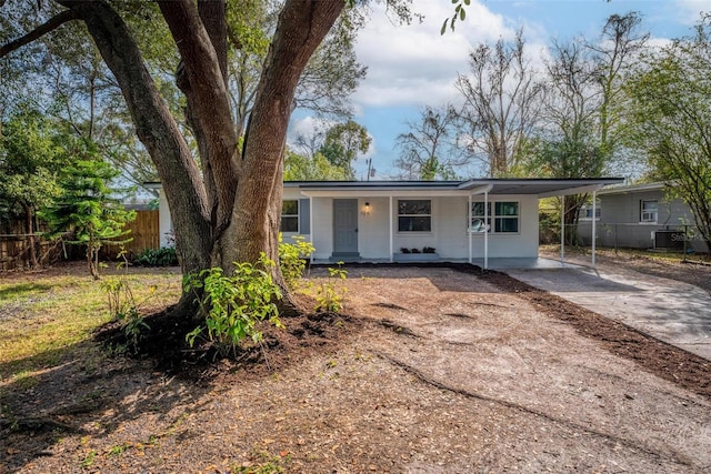 ranch-style home featuring a carport and covered porch