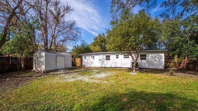 back of property with a storage shed and a lawn