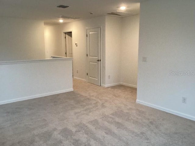 unfurnished room with light carpet