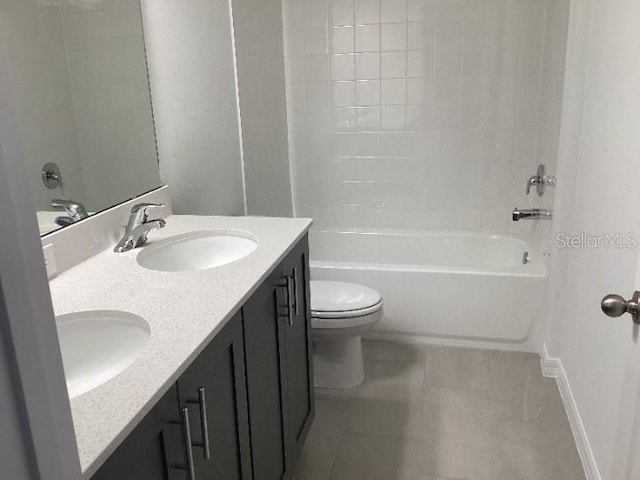 full bathroom with tile patterned flooring, vanity, washtub / shower combination, and toilet