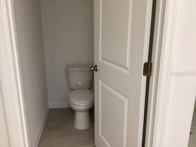 bathroom with tile patterned flooring and toilet