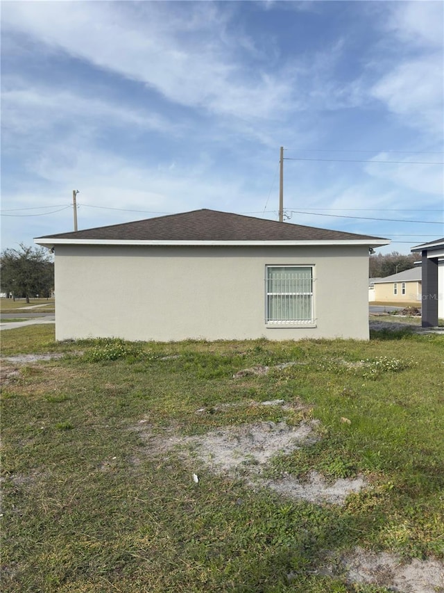 view of side of home with a yard