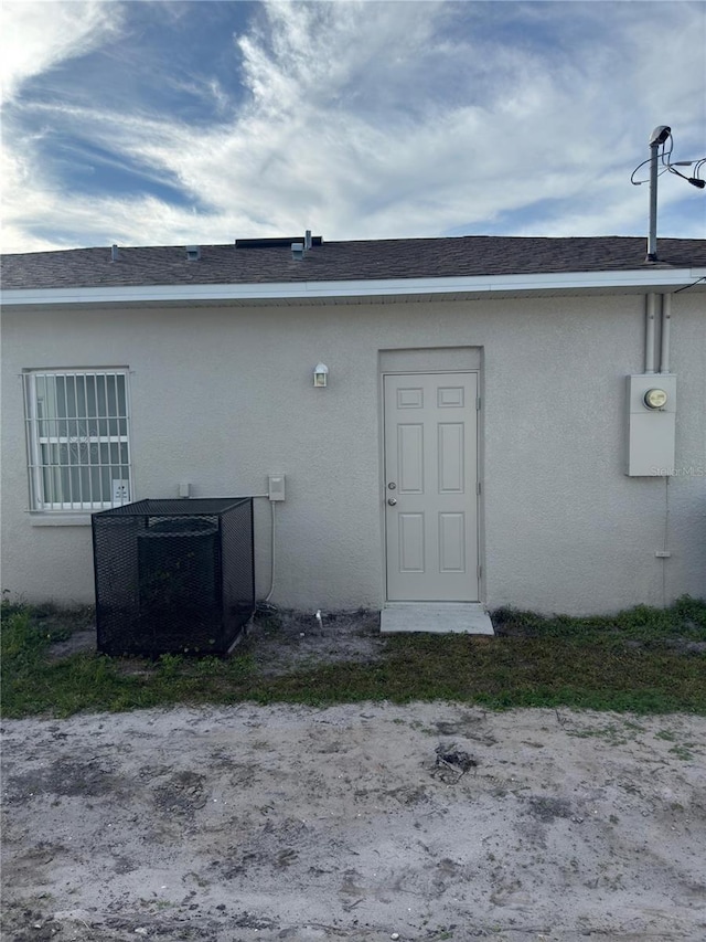 back of house with central air condition unit