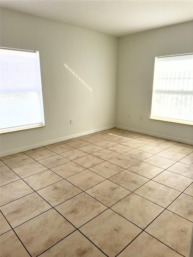 empty room featuring light tile patterned floors