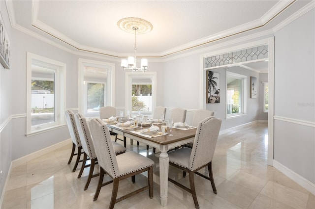 dining area featuring ornamental molding and a chandelier