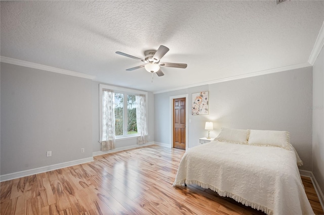 bedroom with crown molding, a textured ceiling, ceiling fan, and light wood-type flooring