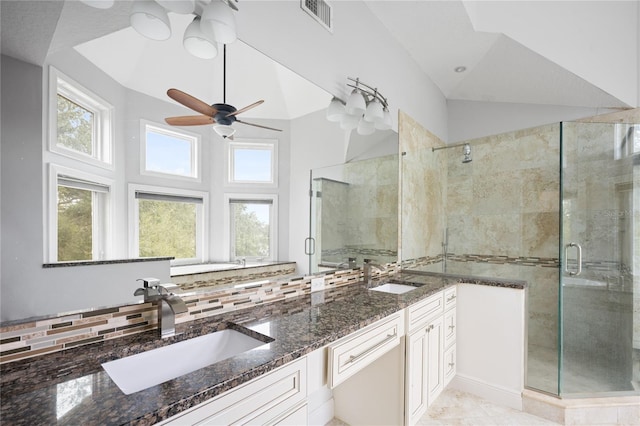 interior space with backsplash, dark stone countertops, sink, and white cabinets