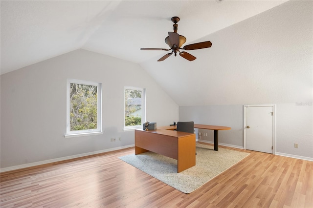 unfurnished office featuring lofted ceiling, ceiling fan, and light wood-type flooring