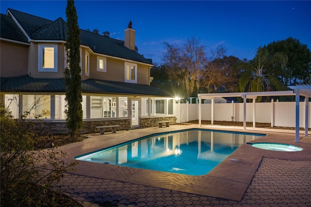 view of pool with an in ground hot tub, a patio area, and a pergola