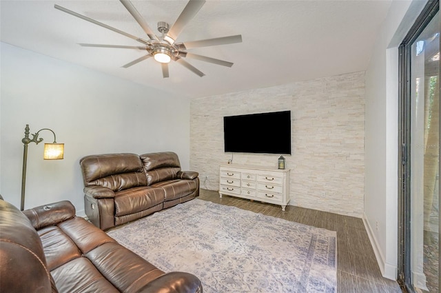 living room with dark hardwood / wood-style floors and ceiling fan