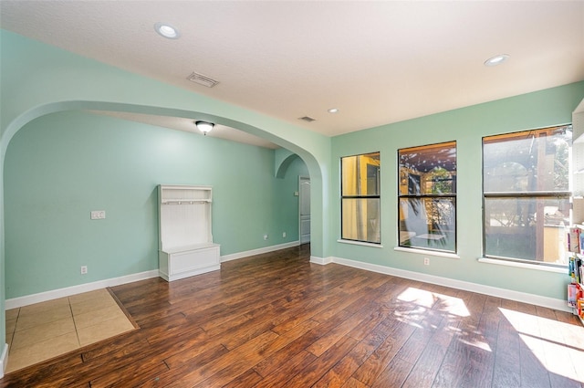 unfurnished living room featuring dark wood-type flooring