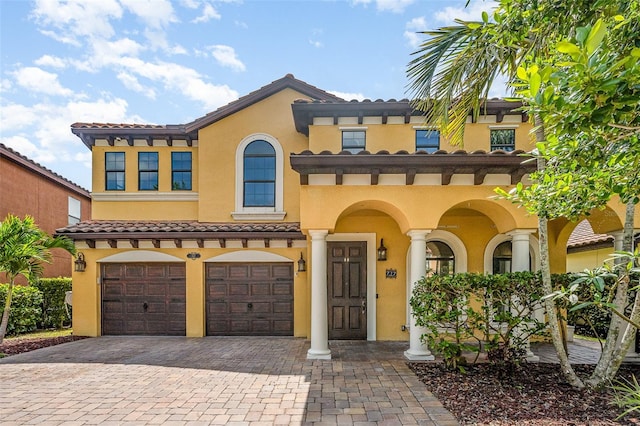 mediterranean / spanish-style home with a garage