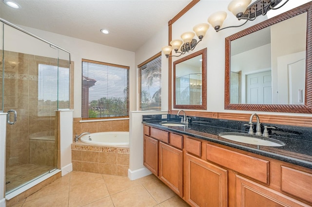 bathroom with tile patterned flooring, vanity, plus walk in shower, and a textured ceiling