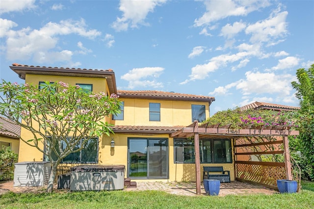 back of house featuring a yard, a pergola, and a patio