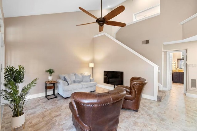 living room with ceiling fan and high vaulted ceiling