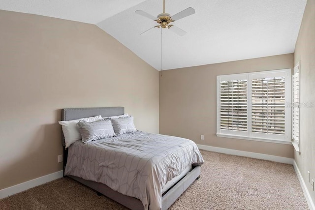 carpeted bedroom featuring vaulted ceiling and ceiling fan