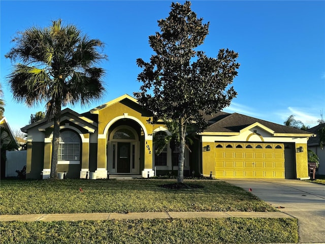 view of front of home with a garage and a front yard