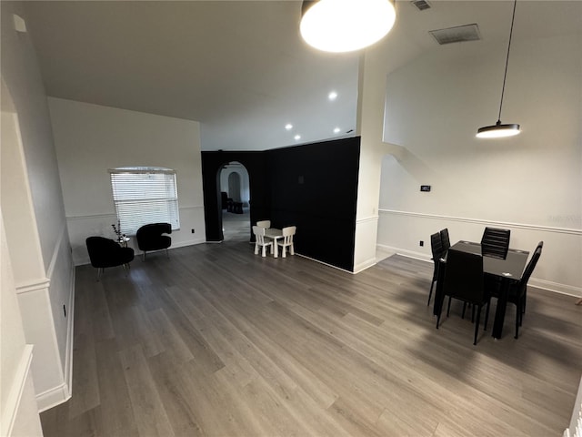 dining space with wood-type flooring