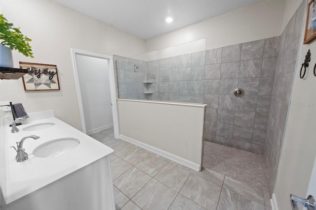 bathroom with vanity, tile patterned floors, and a tile shower