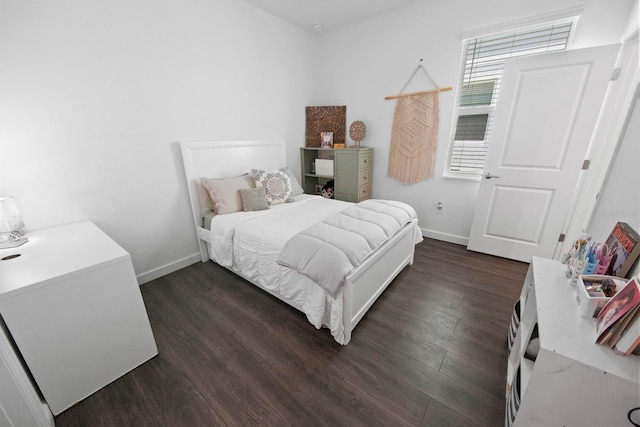 bedroom with dark hardwood / wood-style flooring