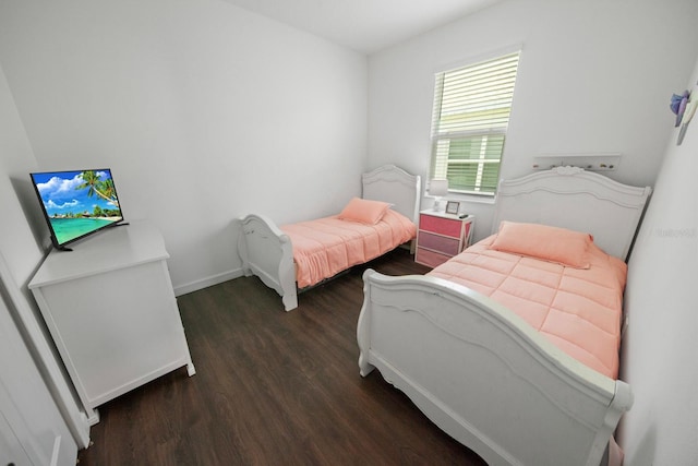 bedroom with dark wood-type flooring