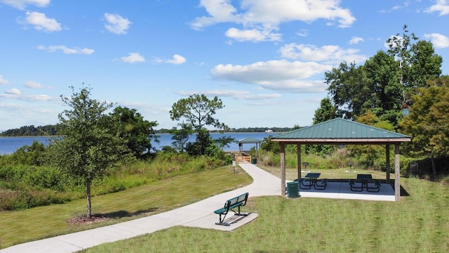 view of community with a gazebo, a water view, and a yard