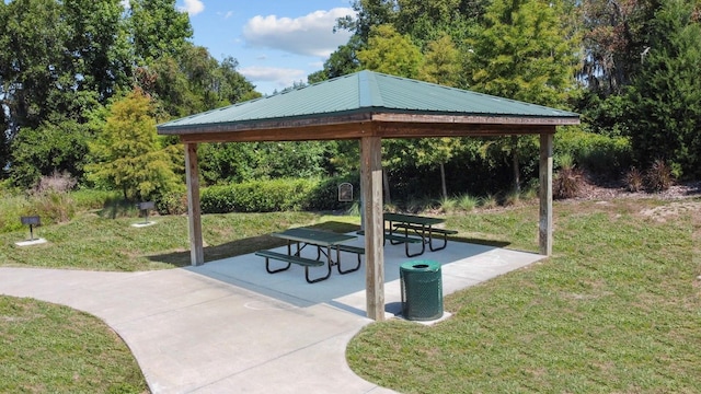 view of community with a yard, a gazebo, and a patio