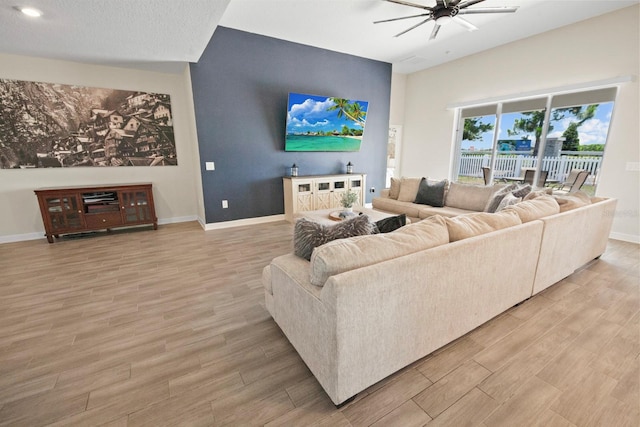 living room featuring light hardwood / wood-style floors and ceiling fan