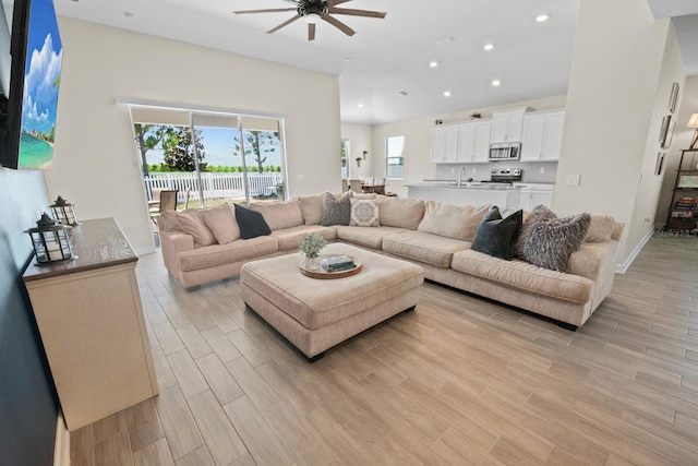 living room with sink and ceiling fan