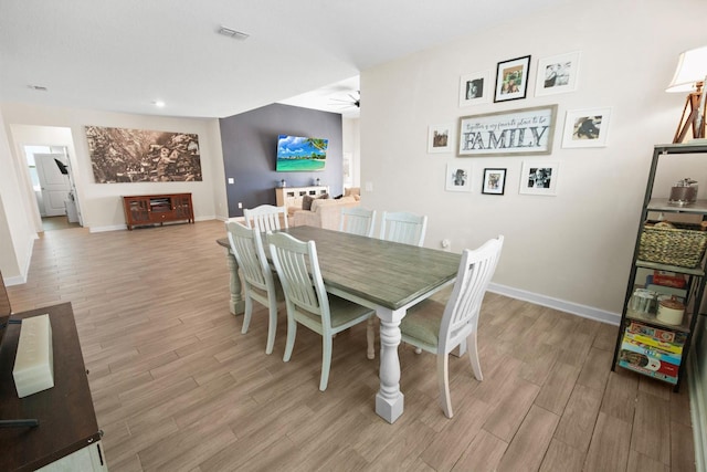 dining room featuring ceiling fan and light hardwood / wood-style flooring