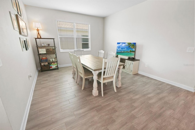 dining space with light wood-type flooring