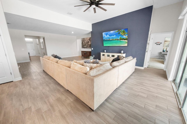 living room with ceiling fan and light hardwood / wood-style floors