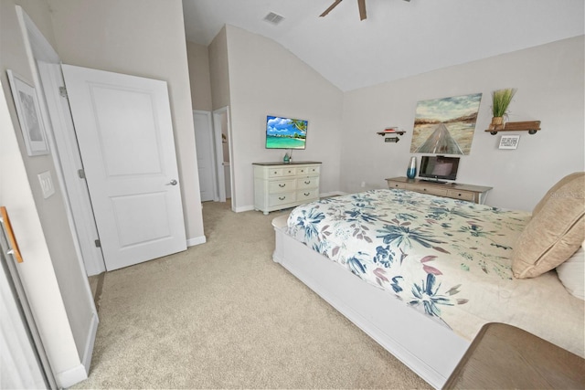 carpeted bedroom with ceiling fan and vaulted ceiling