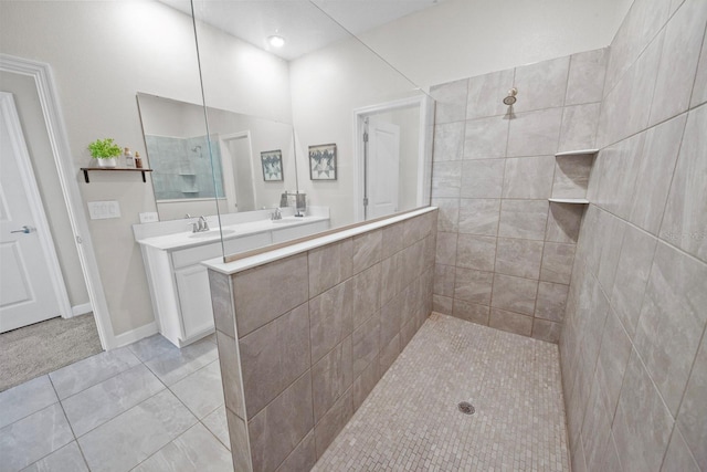 bathroom featuring tiled shower, tile patterned floors, and vanity