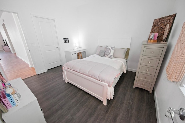 bedroom with dark hardwood / wood-style flooring