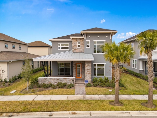 view of front of house with a porch and a front lawn