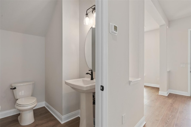 bathroom with hardwood / wood-style floors and toilet