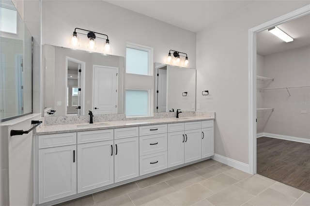 bathroom with vanity, tile patterned floors, and a healthy amount of sunlight