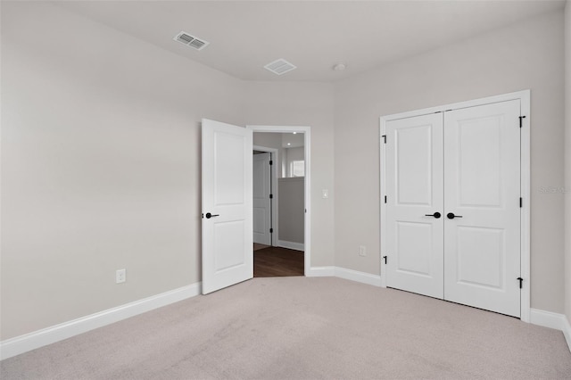 unfurnished bedroom with carpet floors and a closet