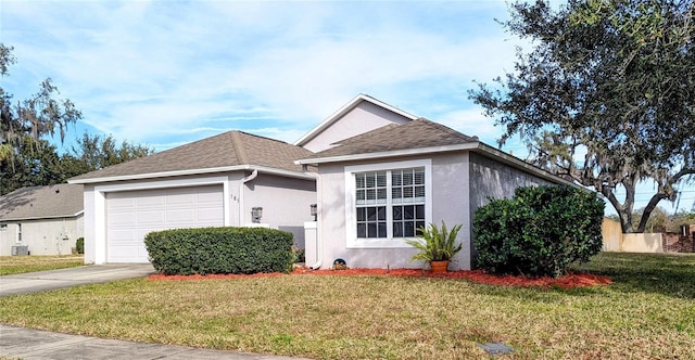 view of front of property with a garage and a front lawn