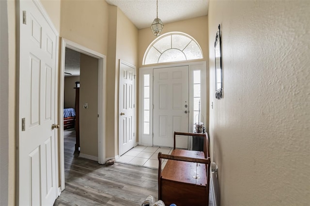 foyer with a textured ceiling and light wood-type flooring