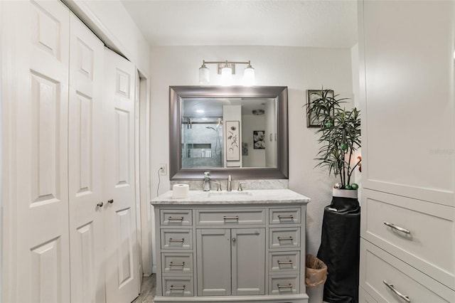 bathroom featuring vanity and a shower with shower door