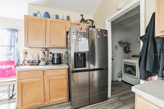 kitchen with light brown cabinetry, washer / clothes dryer, stainless steel fridge with ice dispenser, a textured ceiling, and light wood-type flooring