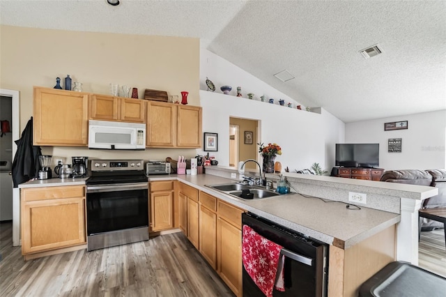 kitchen with vaulted ceiling, sink, kitchen peninsula, dark wood-type flooring, and electric stove