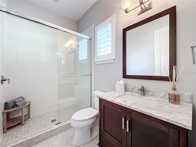 bathroom featuring vanity, tile patterned flooring, toilet, and walk in shower