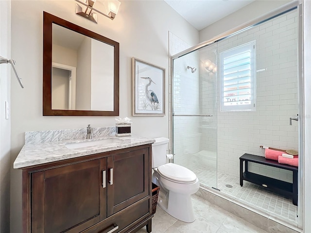 bathroom featuring vanity, toilet, and an enclosed shower