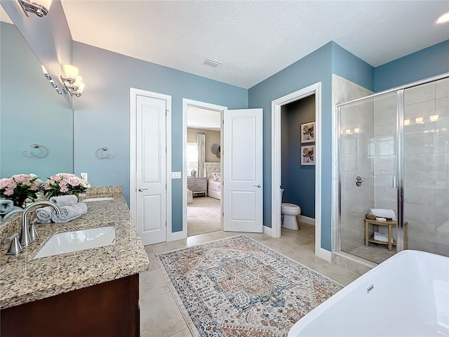 full bathroom with toilet, vanity, plus walk in shower, and a textured ceiling