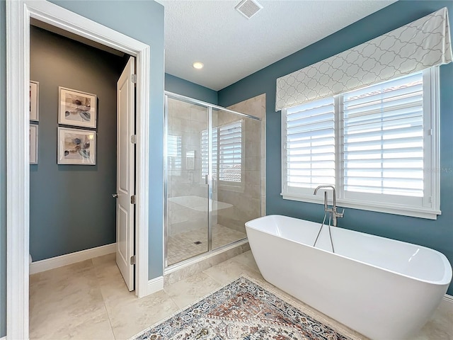 bathroom with shower with separate bathtub and a textured ceiling