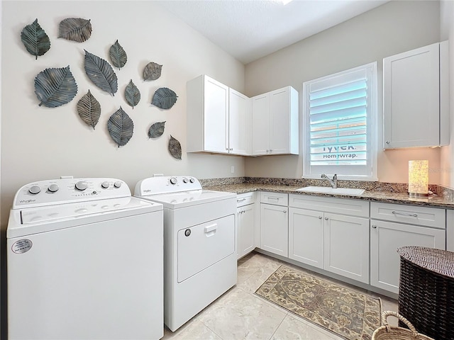 laundry room with washer and dryer, sink, and cabinets