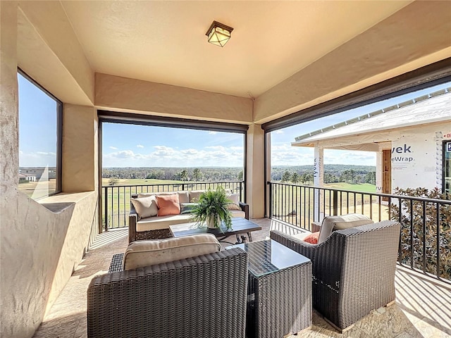 exterior space with a rural view, an outdoor hangout area, and a balcony